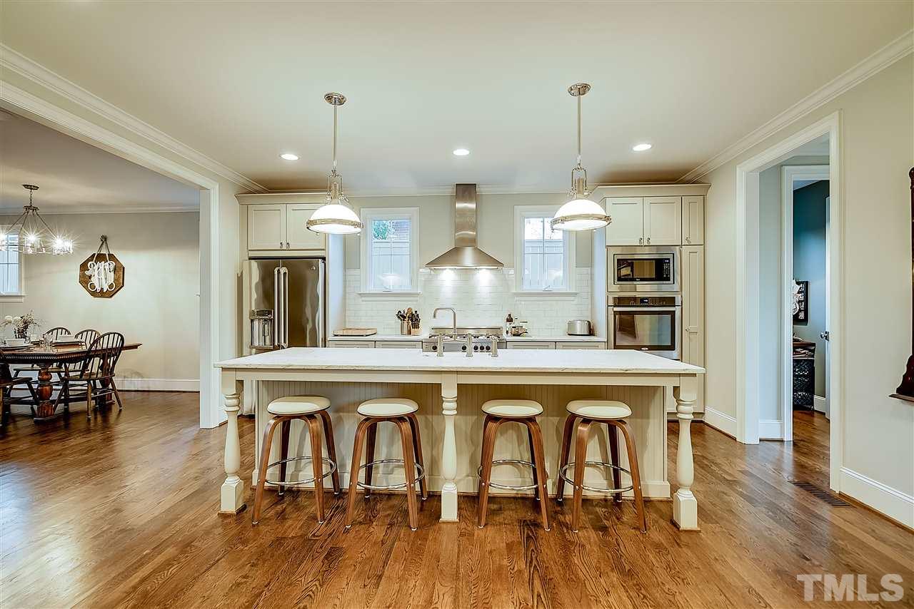 217 Georgetown Road Raleigh, NC 27608 - Photo 6 of 25 a large kitchen with a table and chairs