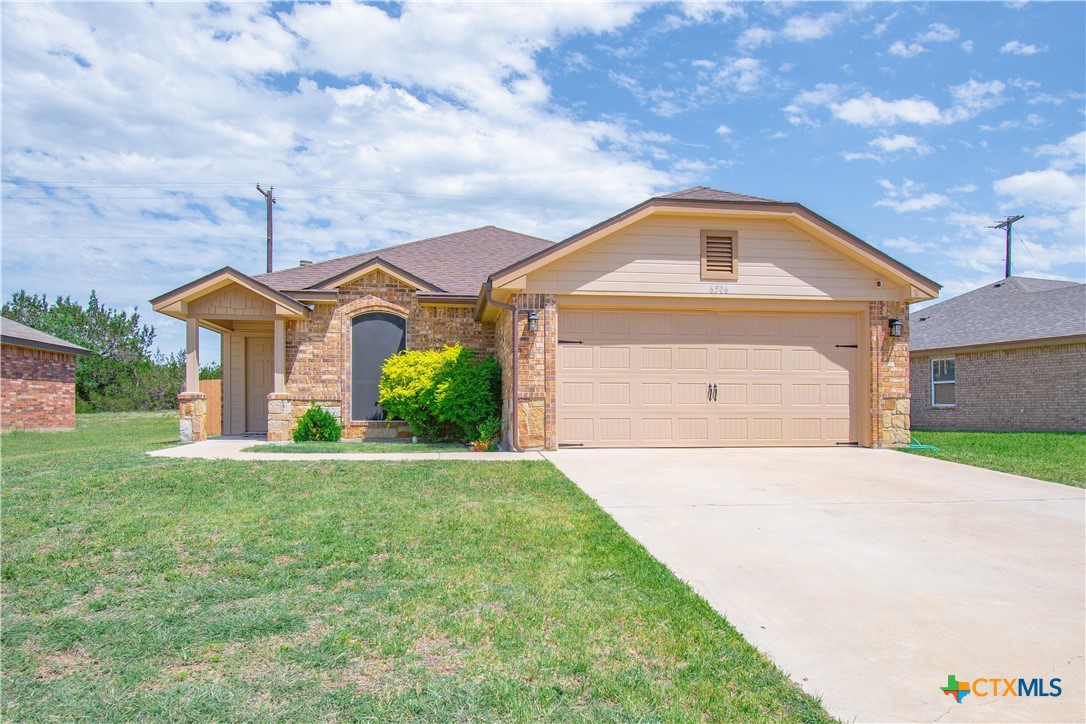 a front view of a house with a yard and garage