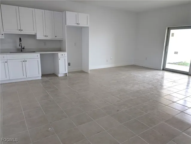 a view of a livingroom with an empty space and a window