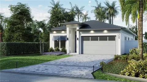 a front view of a house with a yard and potted plants