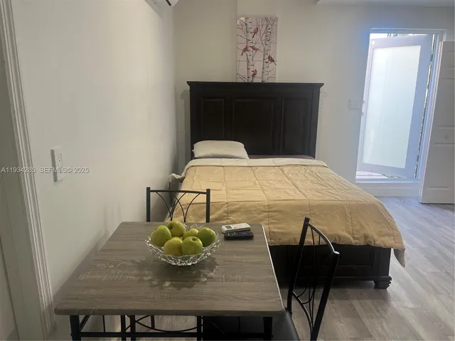 a bedroom with a bed and table