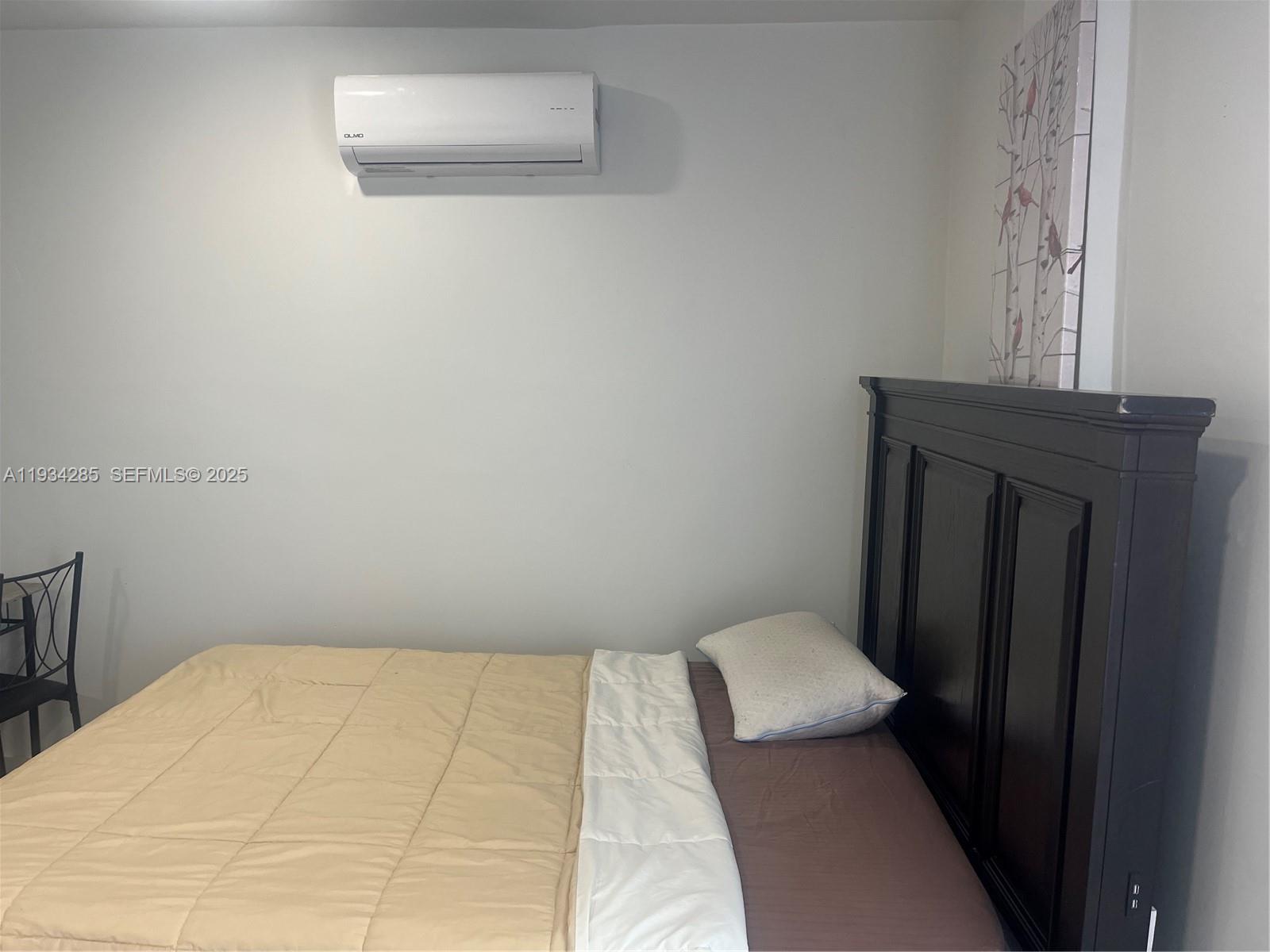 20766 Southwest 85th Place, Unit BACK Cutler Bay, FL 33189 - Photo 6 of 10 a bedroom with a bed and a window