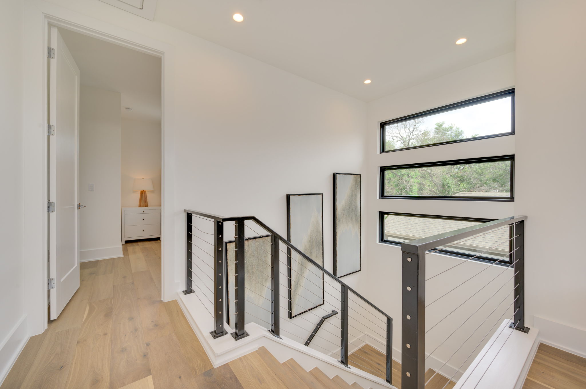 2415 McCall Road Austin, TX 78703 - Photo 31 of 40 Clean lines and natural light define this inviting staircase with durable hardwood flooring.
