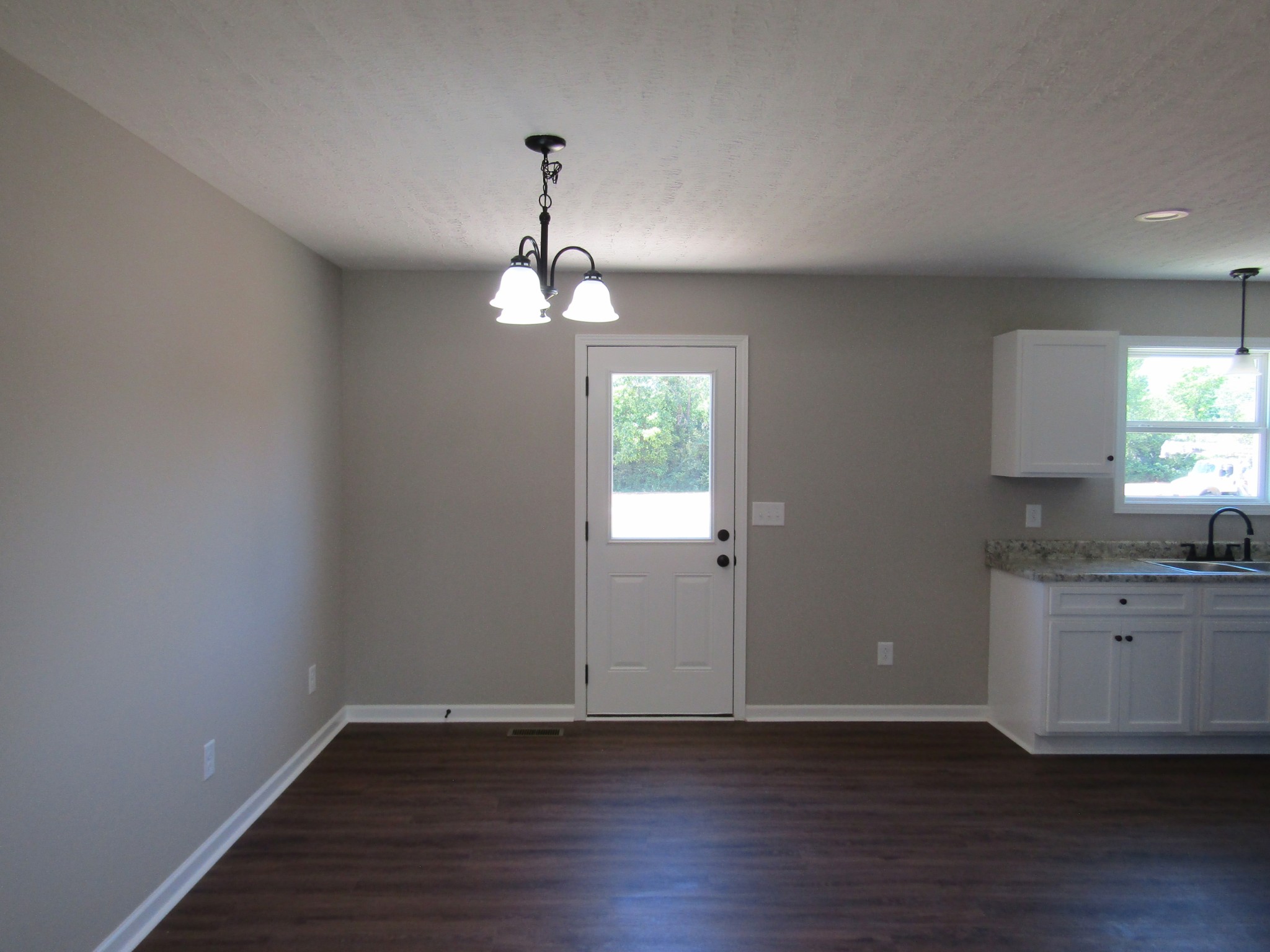 480 Crescent Factory Road Lawrenceburg, TN 38464 - Photo 5 of 14 a view of an empty room with wooden floor and a window