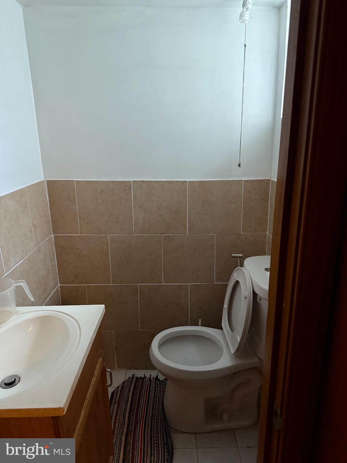 7151 Lynford Street Philadelphia, PA 19149 - Photo 11 of 13 a bathroom with a sink a toilet and a mirror