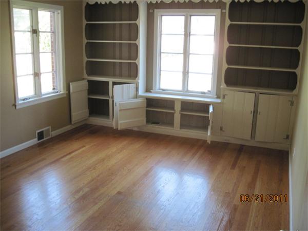 229 Oak Street Springfield, MA 01151 - Photo 4 of 10 an empty room with wooden floor and windows