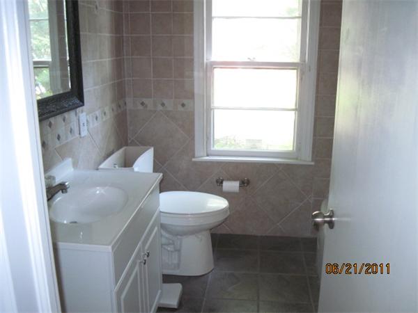 229 Oak Street Springfield, MA 01151 - Photo 5 of 10 a bathroom with a toilet a sink and a window