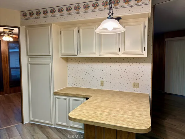 a kitchen with a refrigerator sink and cabinets