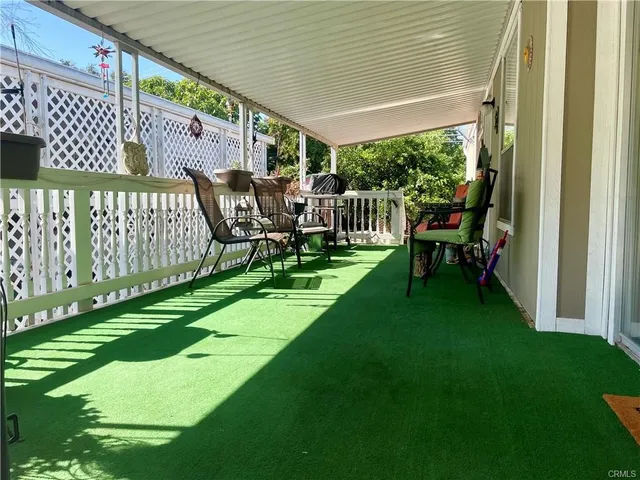 a view of a chair and table on the wooden deck