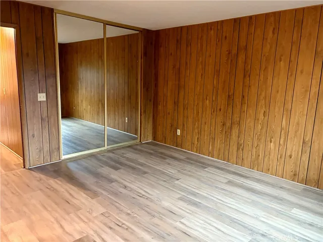 an empty room with wooden floor and a window
