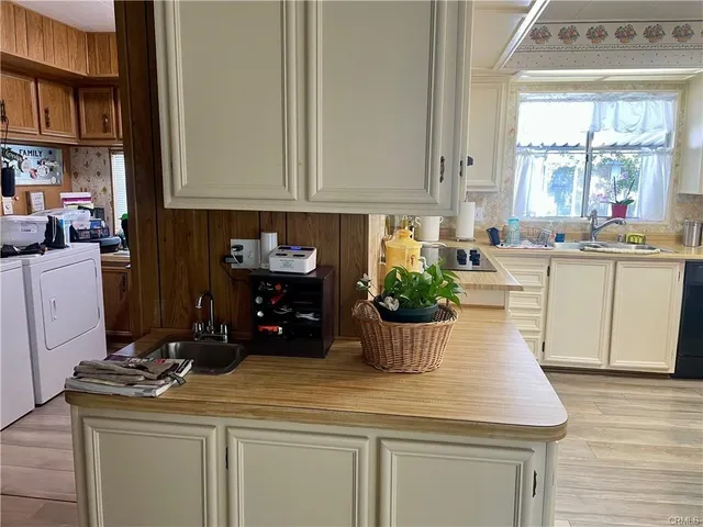 a kitchen with a white stove top oven and white cabinets