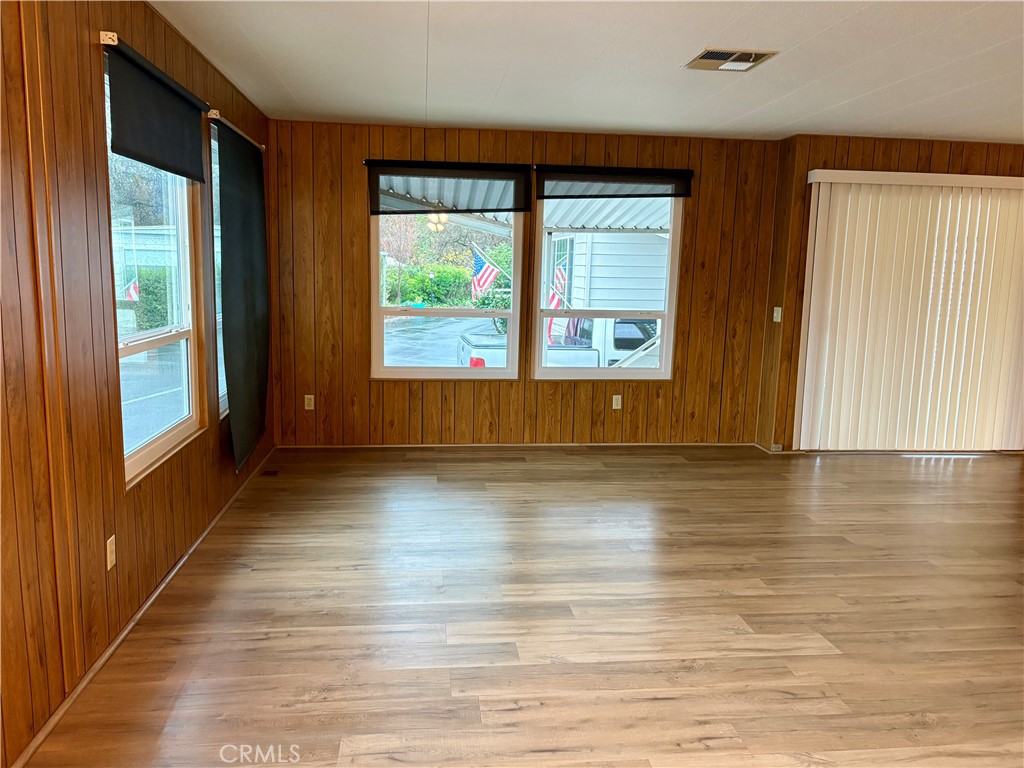 1901 Dayton Road, Unit 6 Chico, CA 95928 - Photo 5 of 25 an empty room with wooden floor and windows