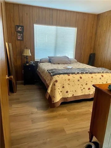 a bedroom with a bed and a flat tv screen