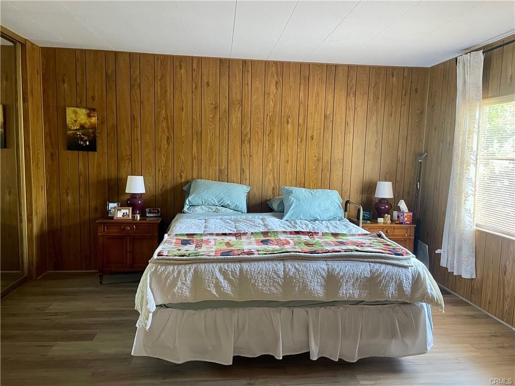 1901 Dayton Road, Unit 6 Chico, CA 95928 - Photo 10 of 16 a bedroom with a bed and wooden floor