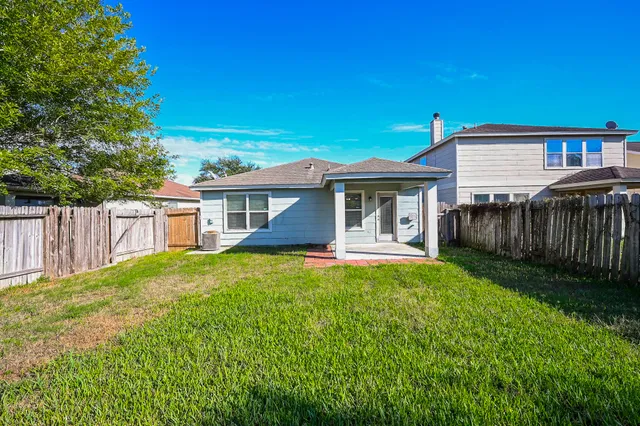 a front view of a house with yard and green space