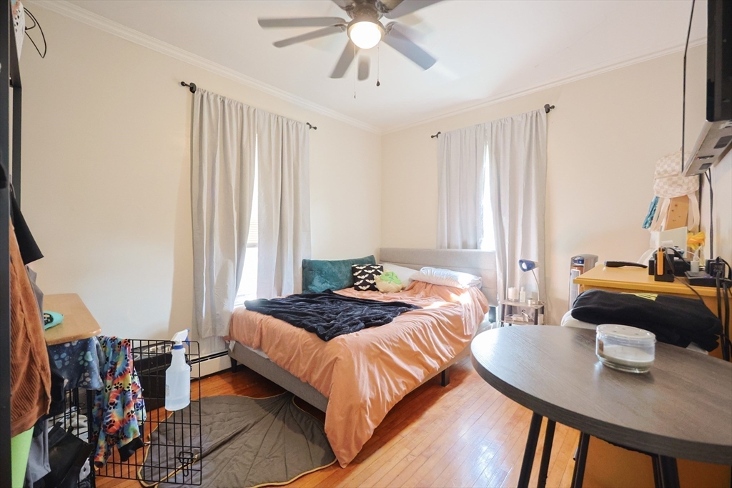 104 Grove Street Fall River, MA 02720 - Photo 12 of 37 a bedroom with a bed and a chandelier