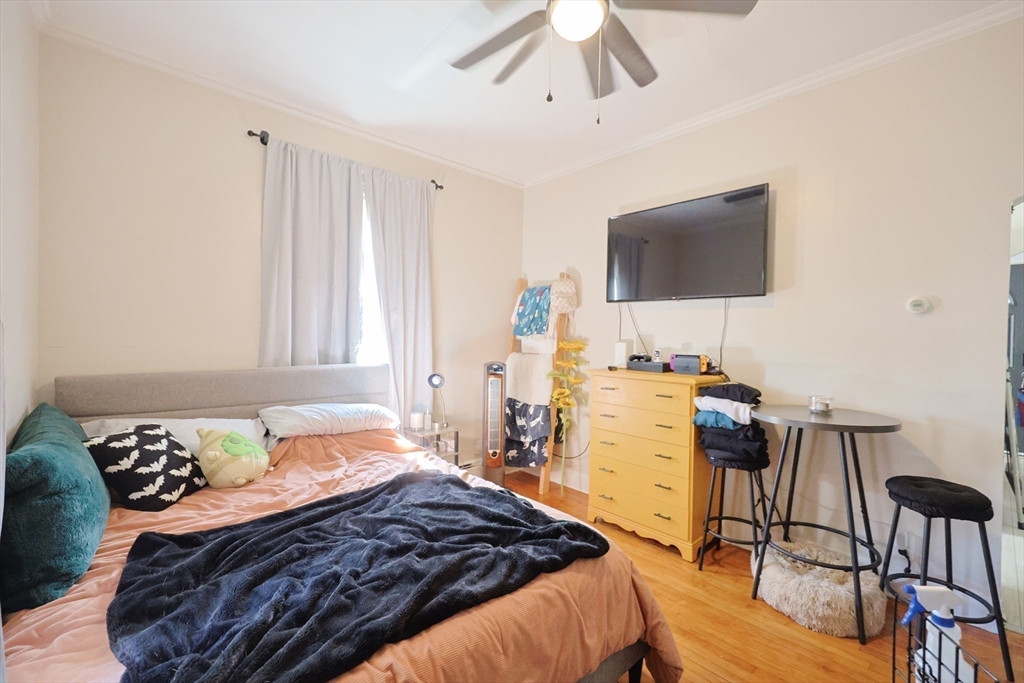 104 Grove Street Fall River, MA 02720 - Photo 13 of 37 a bedroom with a bed and a flat screen tv
