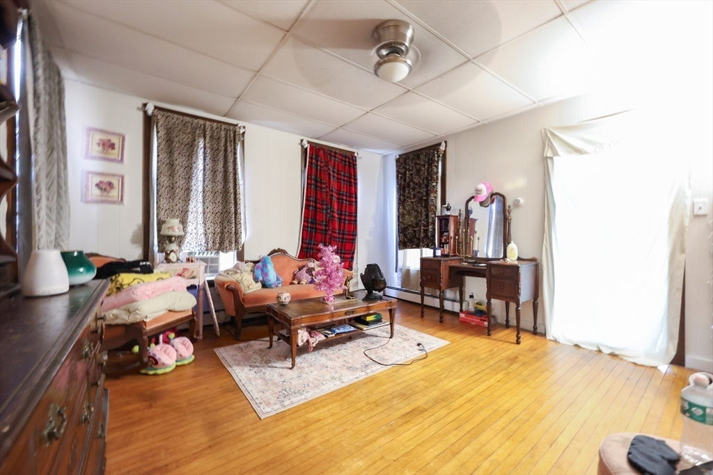 104 Grove Street Fall River, MA 02720 - Photo 17 of 37 a living room with furniture and a flat screen tv