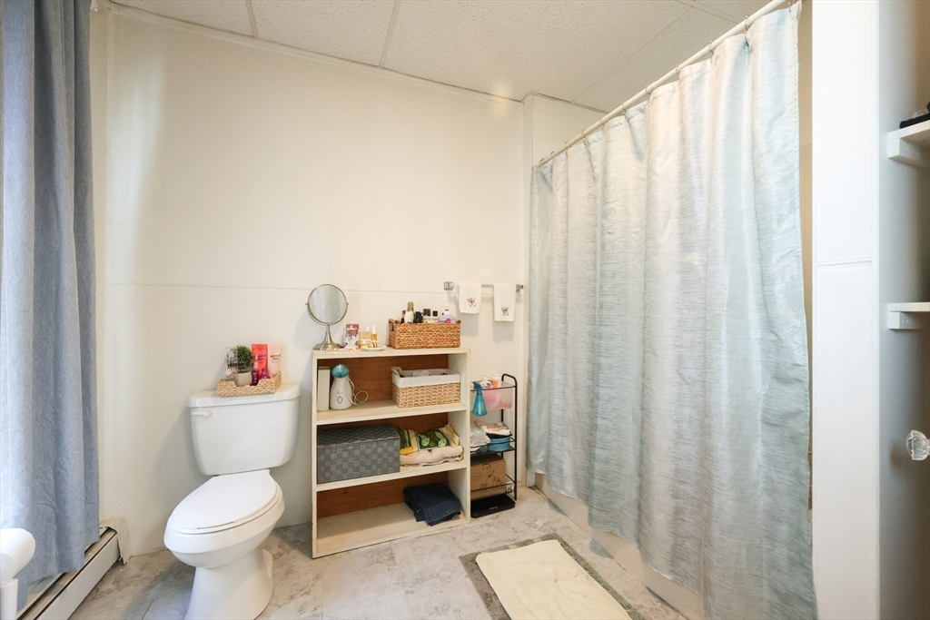 104 Grove Street Fall River, MA 02720 - Photo 18 of 37 a white toilet sitting next to a shower curtain