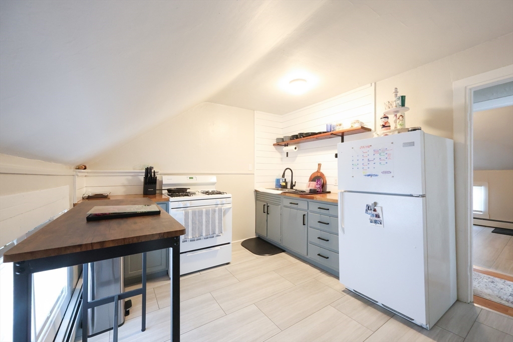 104 Grove Street Fall River, MA 02720 - Photo 20 of 37 a kitchen with cabinets and white appliances