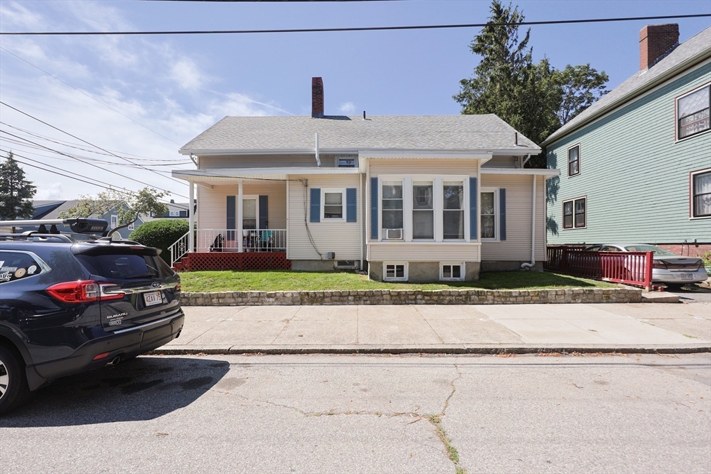 104 Grove Street Fall River, MA 02720 - Photo 2 of 37 a front view of a house with a garden and plants