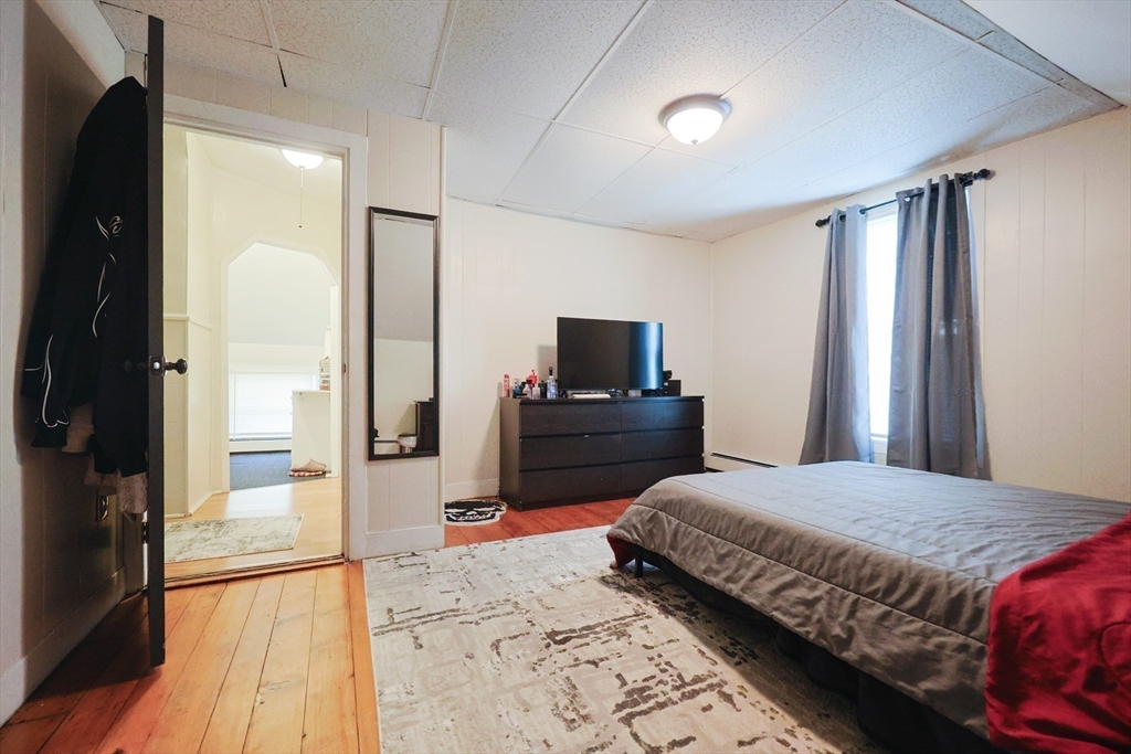 104 Grove Street Fall River, MA 02720 - Photo 22 of 37 a bedroom with a bed and a mirror