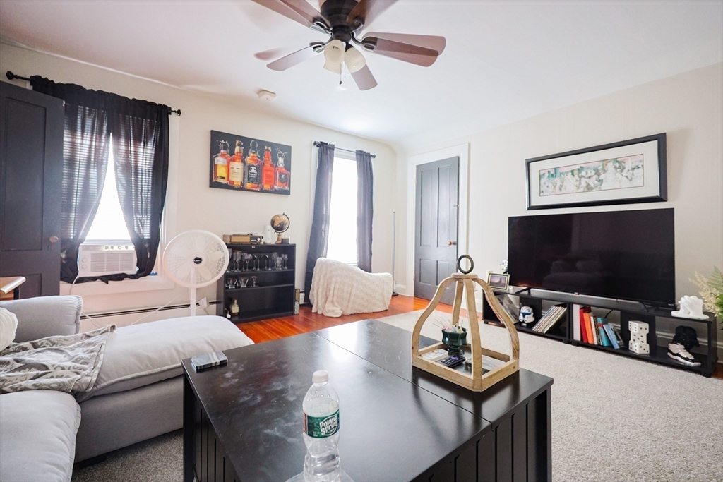 104 Grove Street Fall River, MA 02720 - Photo 26 of 37 a living room with furniture and a flat screen tv