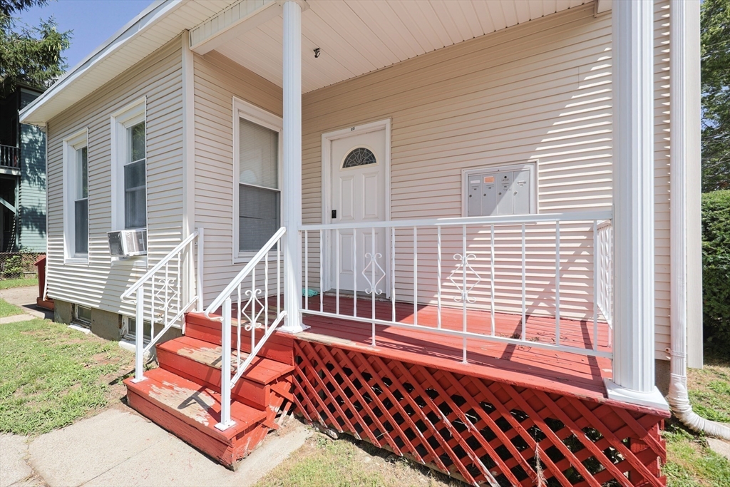 104 Grove Street Fall River, MA 02720 - Photo 31 of 37 a view of a roof deck with wooden floor and fence