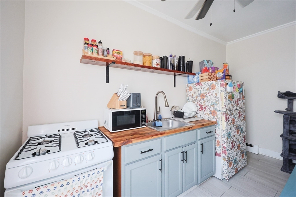 104 Grove Street Fall River, MA 02720 - Photo 10 of 37 a kitchen with stainless steel appliances a white stove top oven a sink and dishwasher