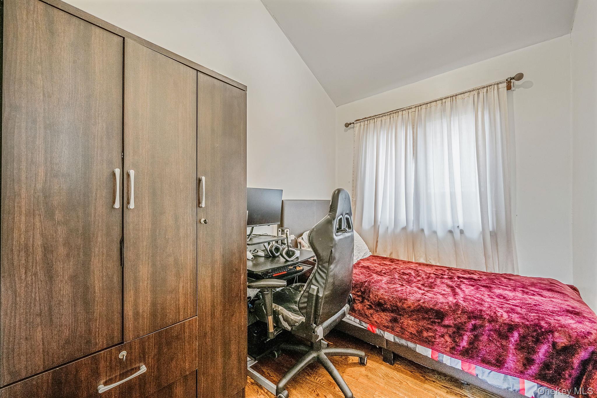 84-70 159th Street Queens, NY 11432 - Photo 15 of 50 Bedroom featuring lofted ceiling, a desk, and light wood-style floors