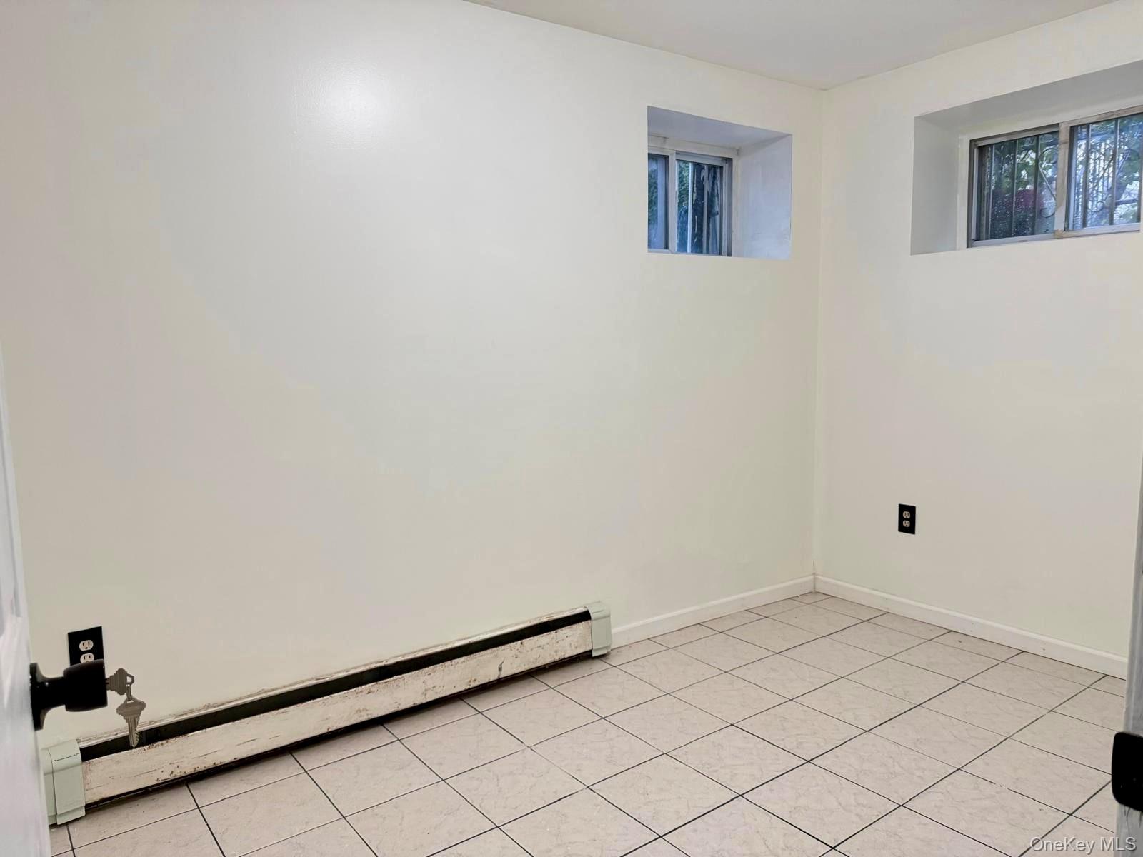 84-70 159th Street Queens, NY 11432 - Photo 29 of 50 Unfurnished room featuring baseboard heating and light tile patterned floors