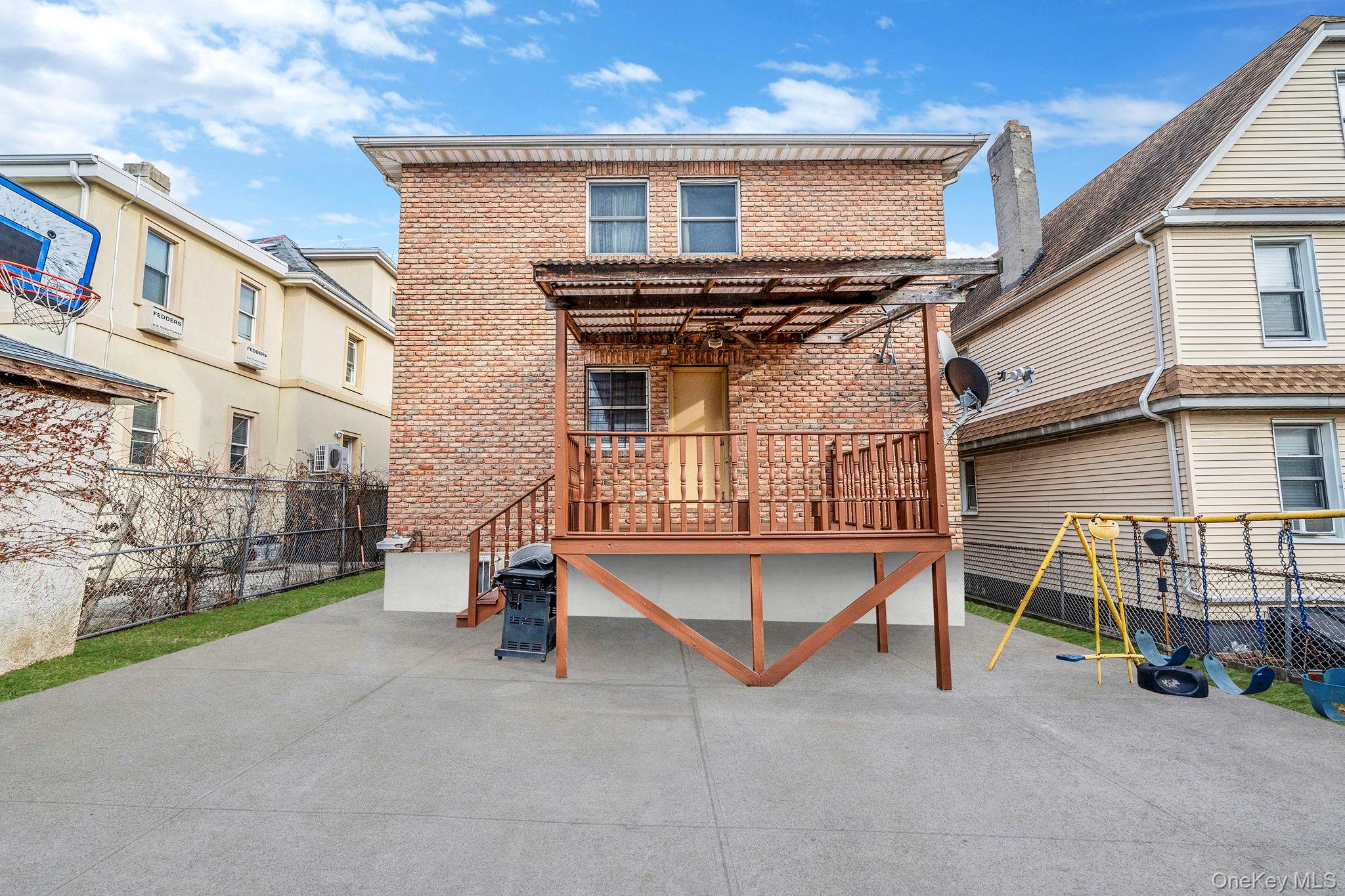 84-70 159th Street Queens, NY 11432 - Photo 35 of 50 Back of property featuring brick siding, a patio, and a pergola