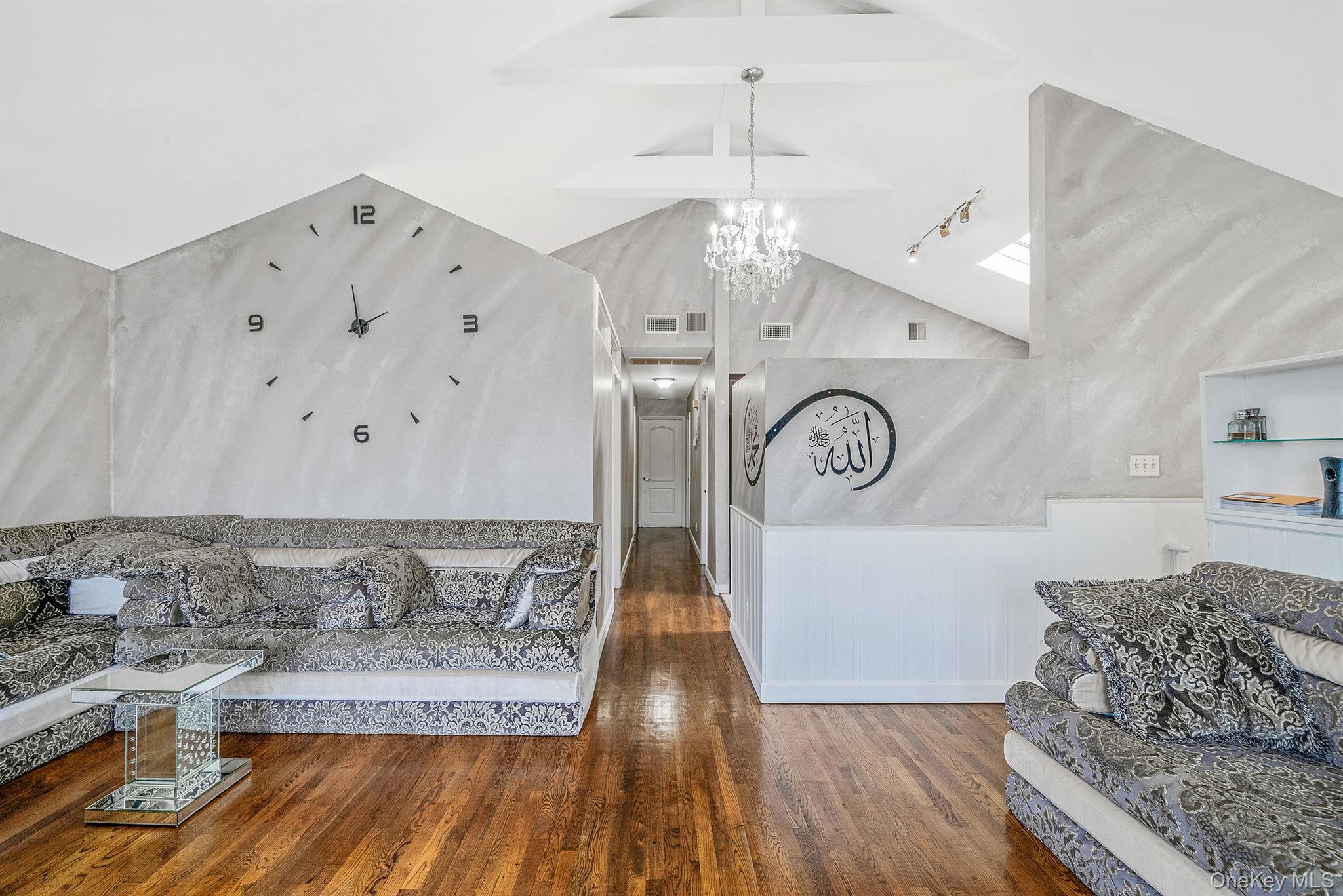 84-70 159th Street Queens, NY 11432 - Photo 6 of 50 Living room featuring dark wood-type flooring, a chandelier, and rail lighting