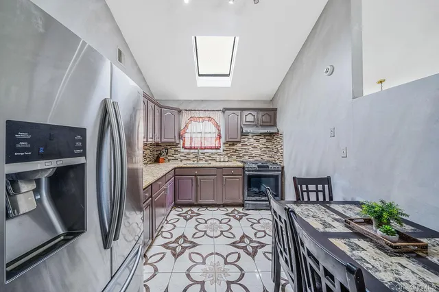 a kitchen with granite countertop a sink and a stove