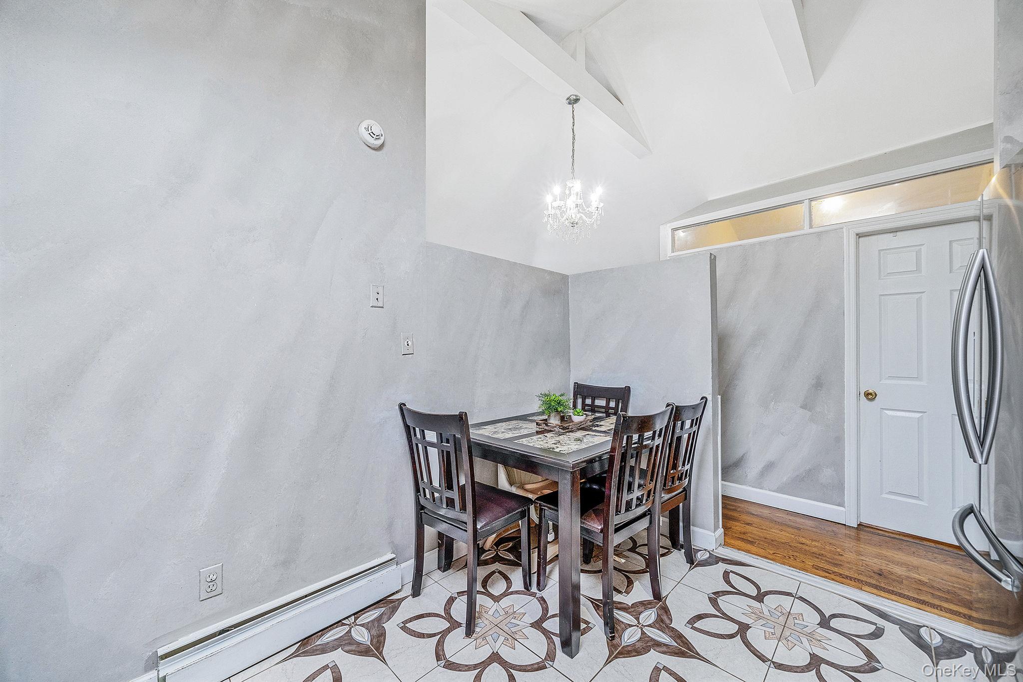 84-70 159th Street Queens, NY 11432 - Photo 10 of 50 Dining room with a baseboard heating unit, beamed ceiling, a chandelier, and high vaulted ceiling