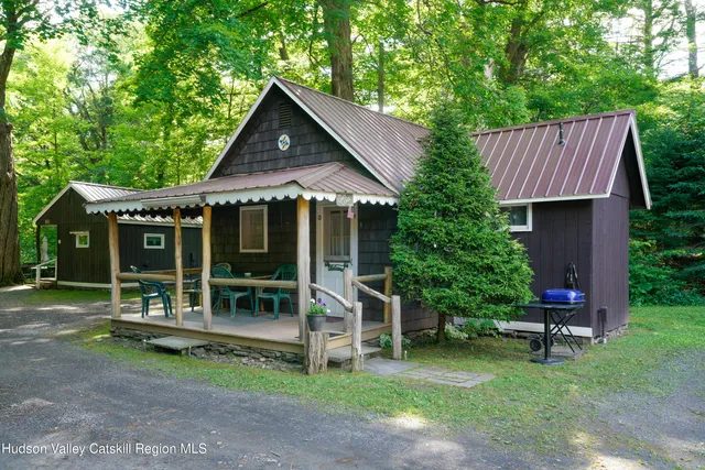 a front view of a house with a yard table and chairs