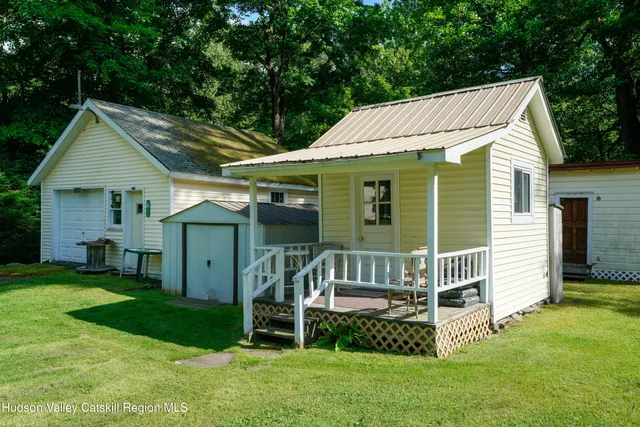 a view of a house with a yard and deck
