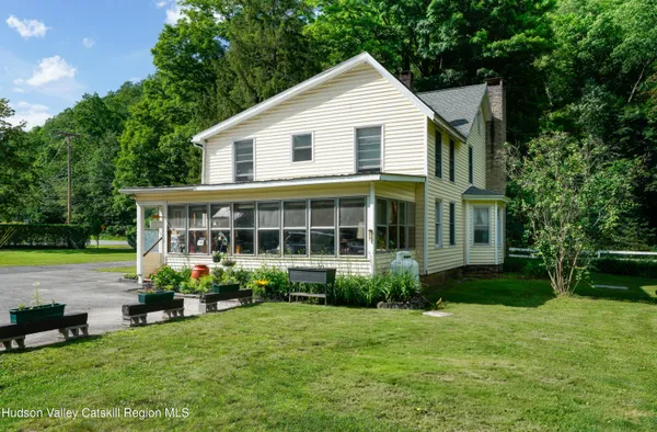 a view of a house with backyard sitting area and garden