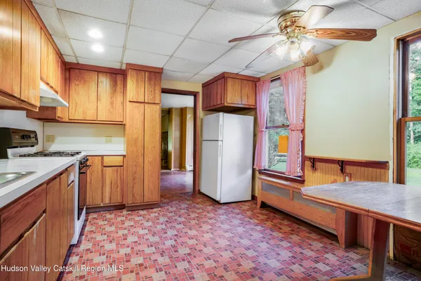 a kitchen with refrigerator and cabinets