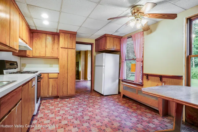 a kitchen with refrigerator and cabinets