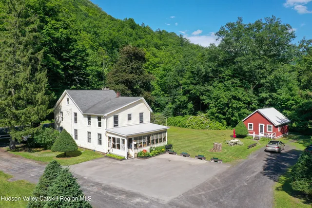 an aerial view of a house with yard and green space