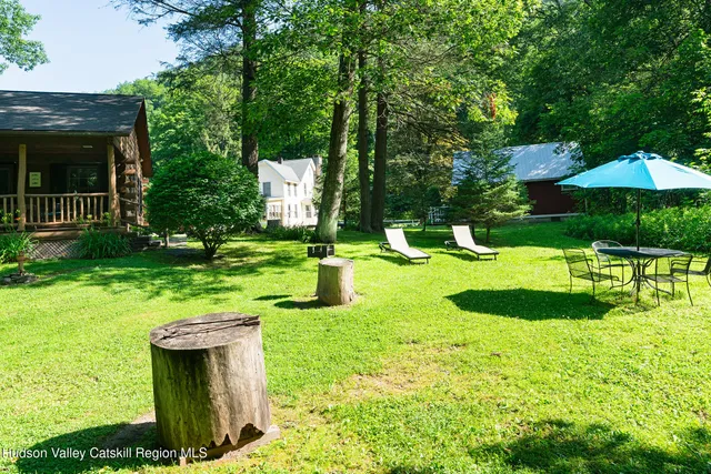 a swimming pool with outdoor seating and yard