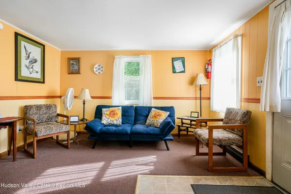 a living room with furniture and a large window