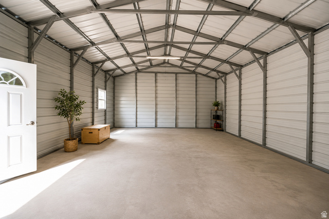 305 West Elmo Road Elmo, UT 84521 - Photo 26 of 27 Spacious metal-frame structure with a high ceiling and concrete flooring