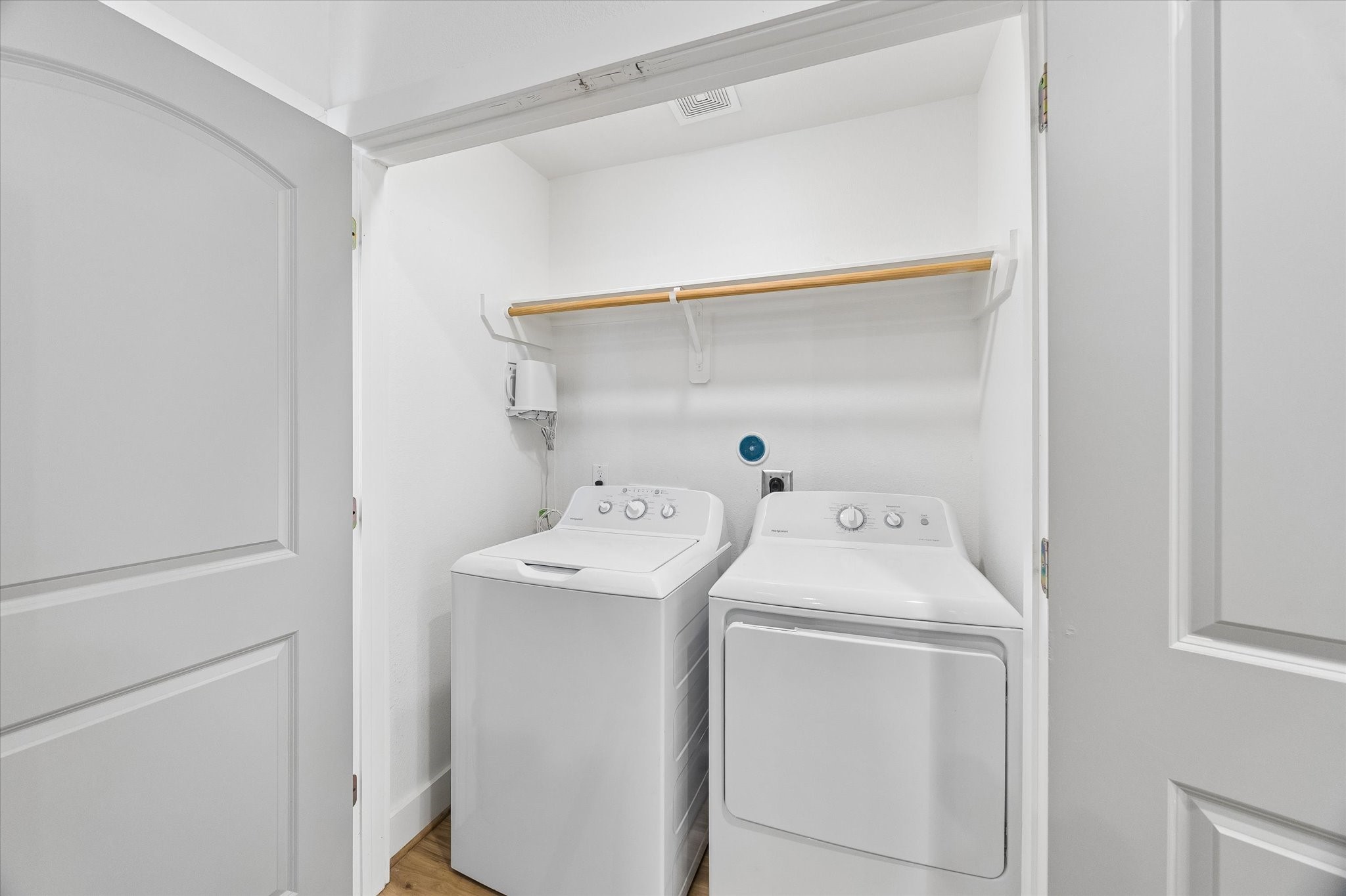 2749 Redrock Street, Unit B Houston, TX 77088 - Photo 12 of 24 Located off the kitchen and tucked away behind double doors is the laundry area complete with upper shelf & hanging storage, full-size washer & dryer included.
