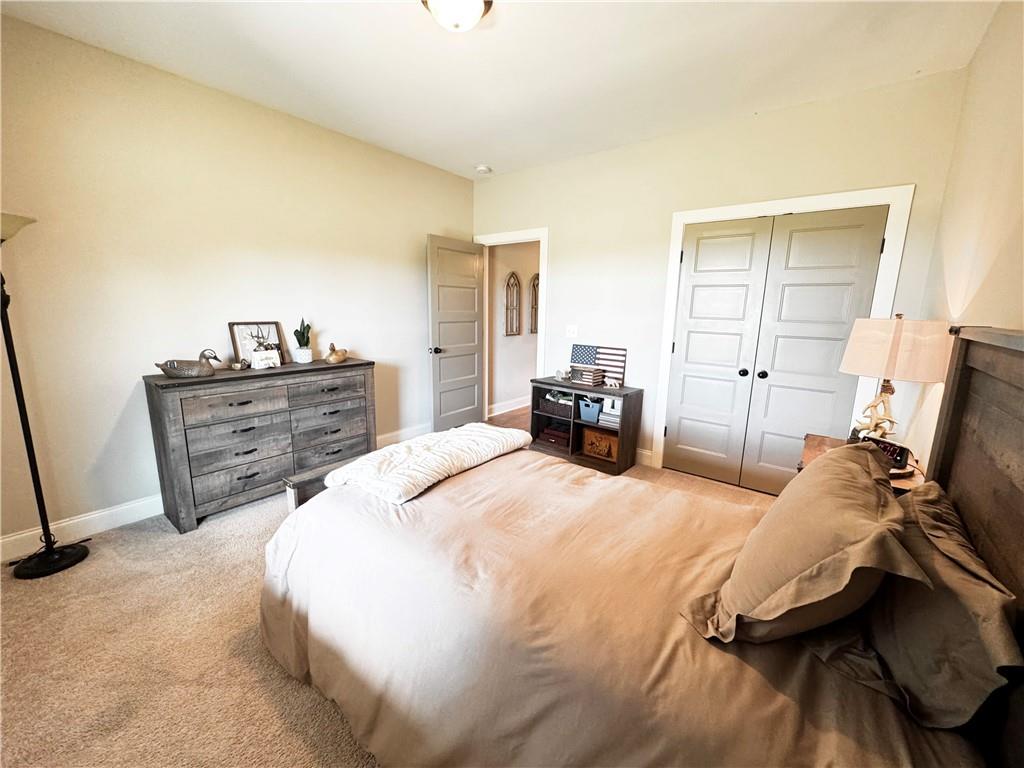 4515 Jacksonville Road Tallapoosa, GA 30176 - Photo 20 of 40 a bedroom with a bed and dresser with mirror