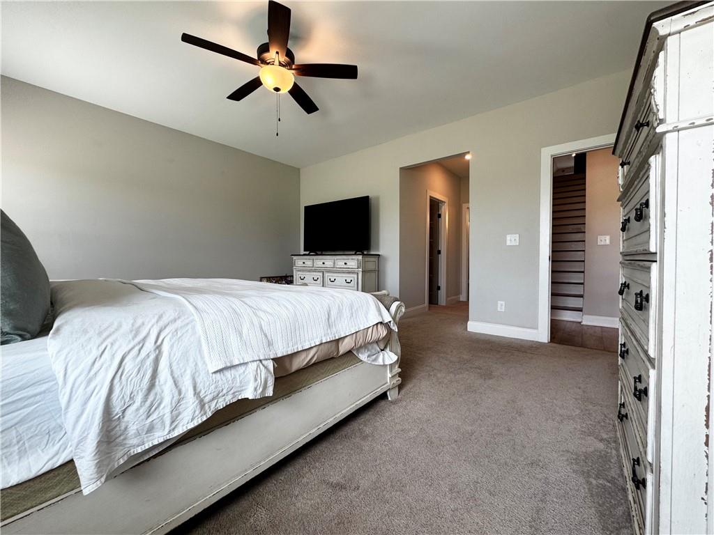 4515 Jacksonville Road Tallapoosa, GA 30176 - Photo 26 of 40 a bedroom with bed and a chandelier