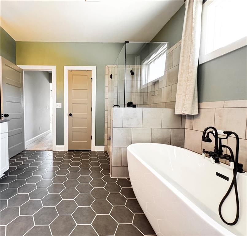4515 Jacksonville Road Tallapoosa, GA 30176 - Photo 29 of 40 a bathroom with a bathtub and a shower