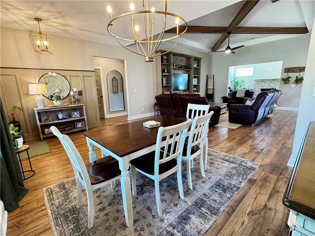 4515 Jacksonville Road Tallapoosa, GA 30176 - Photo 7 of 40 a dining room with furniture a chandelier and wooden floor