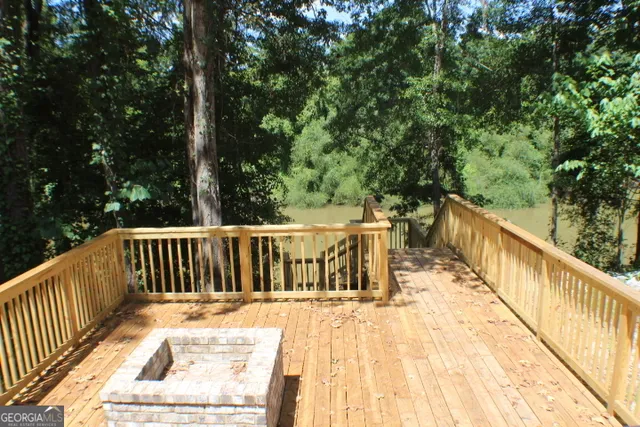 a view of balcony with wooden floor and fence